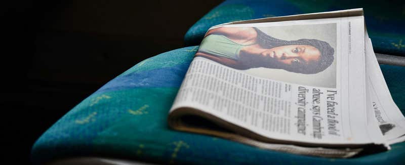 Folded evening newspaper left on a bus seat