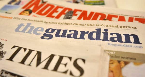 A stack of national newspaper front pages including the Guardian, The Times and the Independent