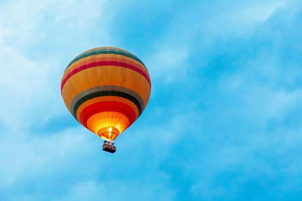 Tourist ariel balloon in flight against a blue sky, Marai Mara, Kenya, Africa