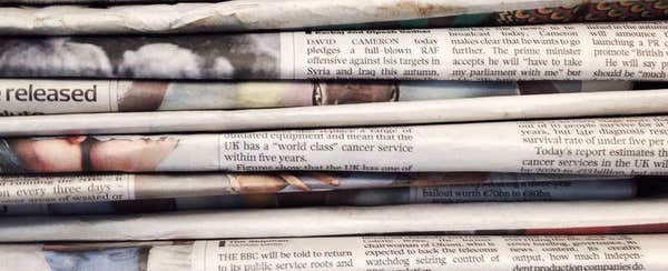 A close-up stack of folded newspapers