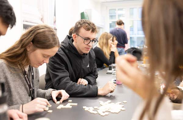 Students working through a written exercise together at a table