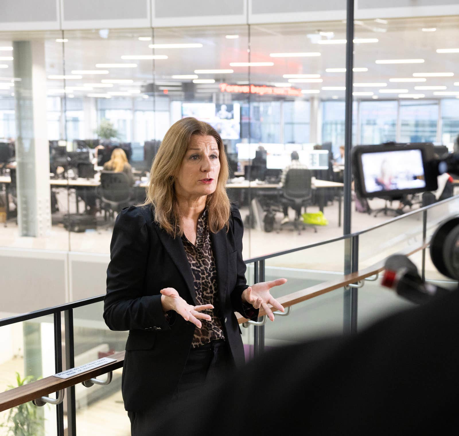 Speaking to camera above the newsroom at the Press Association Academy