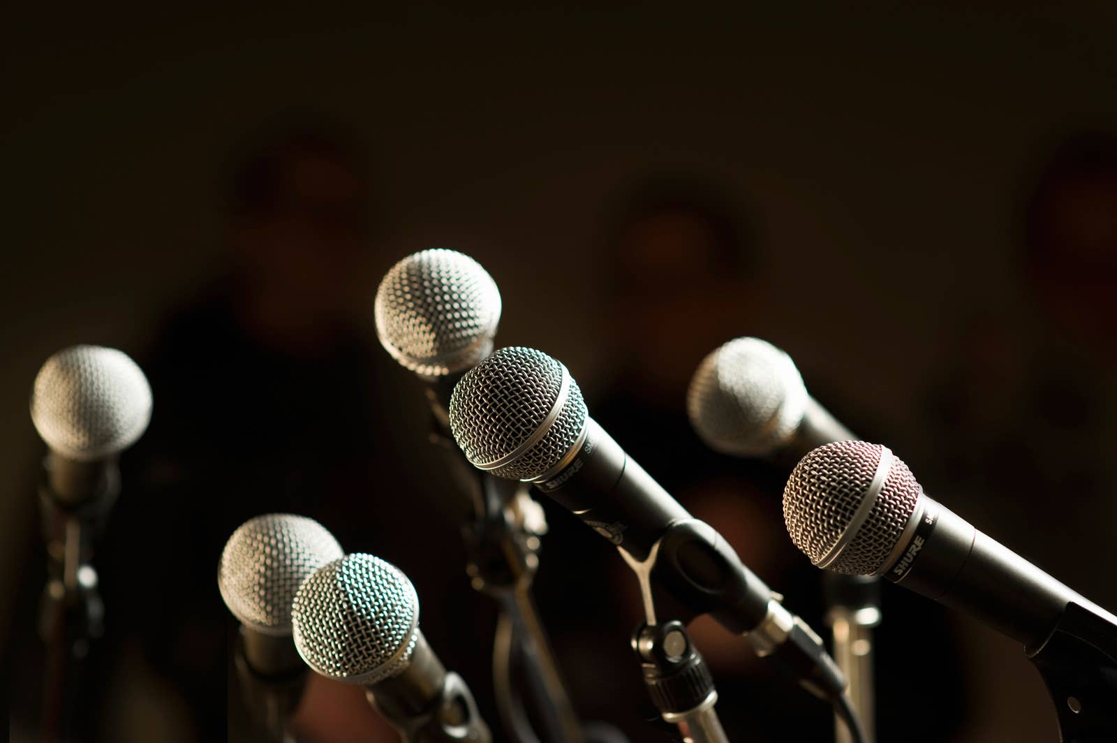 A group of microphones set up for a news conference