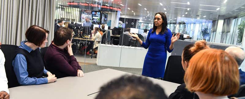 Trainer addressing delegates in a newsroom media-training session