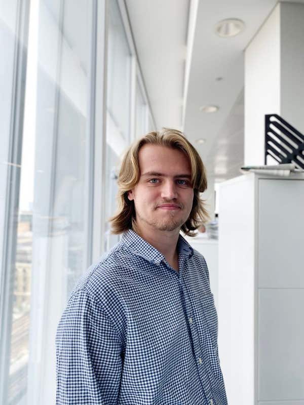 Portrait of a journalism trainee standing beside a window