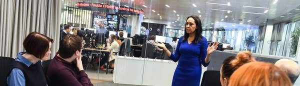 Trainer addressing delegates in a newsroom media-training session
