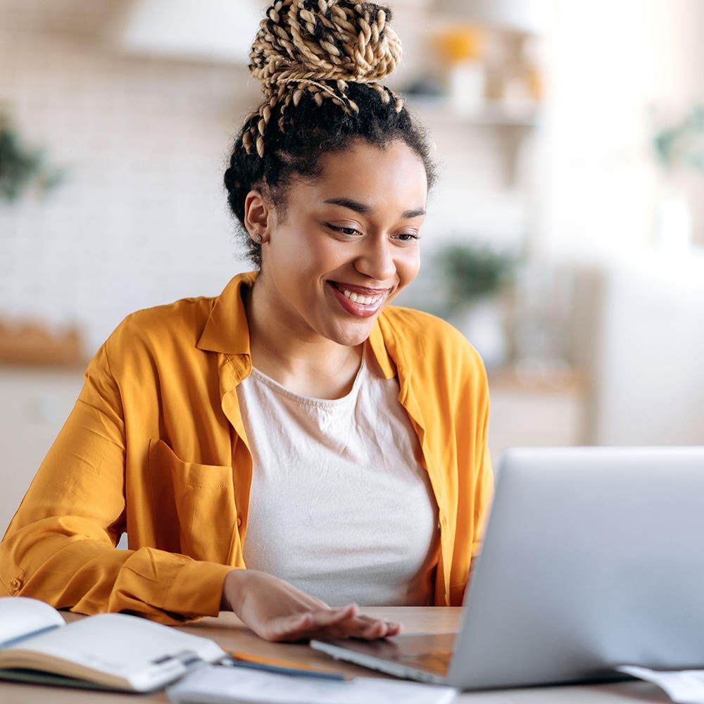 Feature writer training - woman writes at a laptop