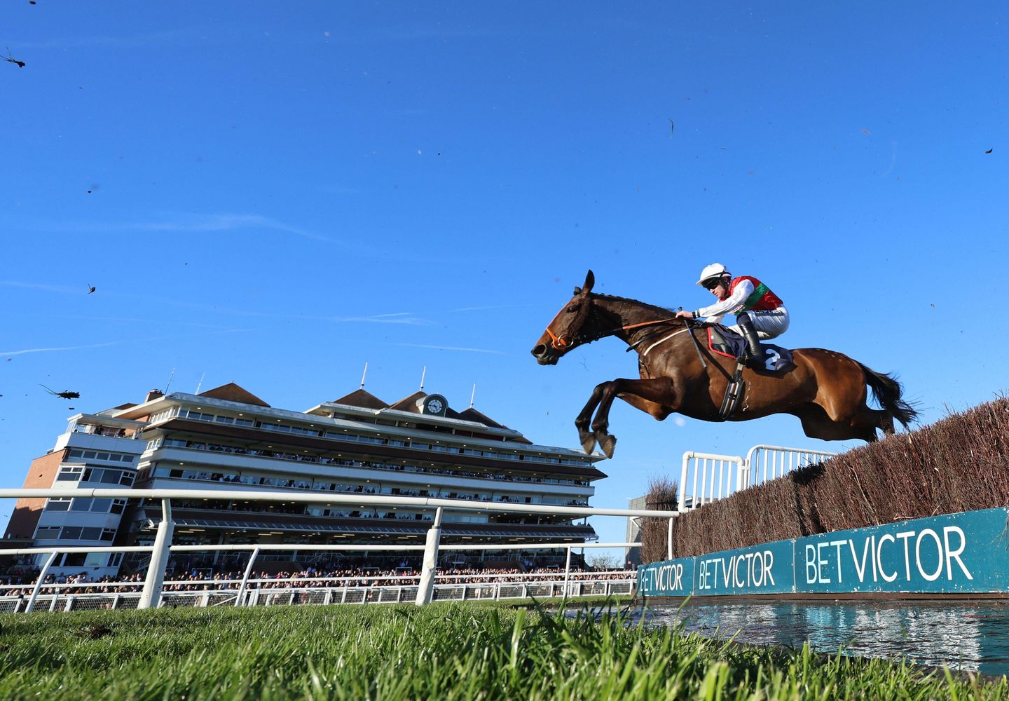 Manothepeople ridden by Jonathan Burke during the Win Unique Experiences At OLBG Prizes Handicap Chase (GBB Race) at Newbury racecourse. Picture date: Saturday March 21, 2026.