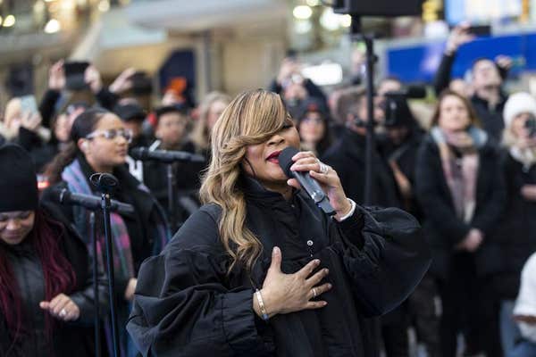 EDITORIAL USE ONLY Gabrielle performs in front of commuters at London Waterloo Station along with Actimel who is looking to e