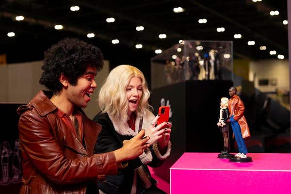 EDITORIAL USE ONLY Cosplayers Dominic G Martin and Charlotte Woolrych with the Doctor Who Barbie dolls, in the likeness of ac