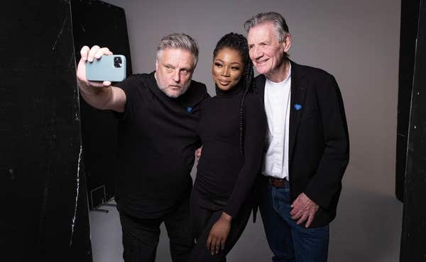 EDITORIAL USE ONLY Nafisat Ibrahim (centre), 25, from London and Michael Palin (right) during a photoshoot with Rankin (left)