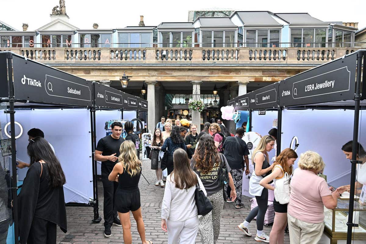 EDITORIAL USE ONLY Shoppers visit stalls at the first TikTok Market hosted at the Covent Garden Piazza in London, with LIVE s
