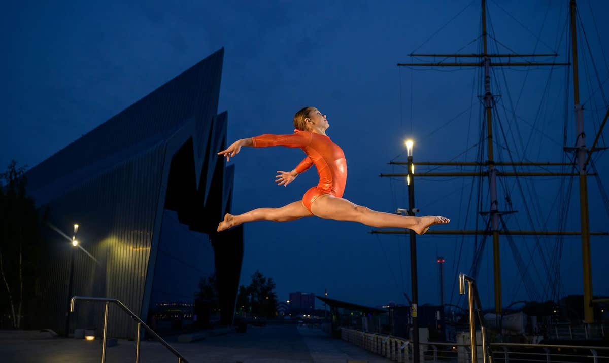 EDITORIAL USE ONLY Scottish Gymnast Indira Williams performs at Riverside Museum in Glasgow at sunset as part of an EDF campa