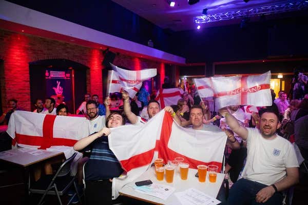 EDITORIAL USE ONLY Football fans watch David Baddiel, Frank Skinner and Lighting Seeds performing their song Three Lions’ at 