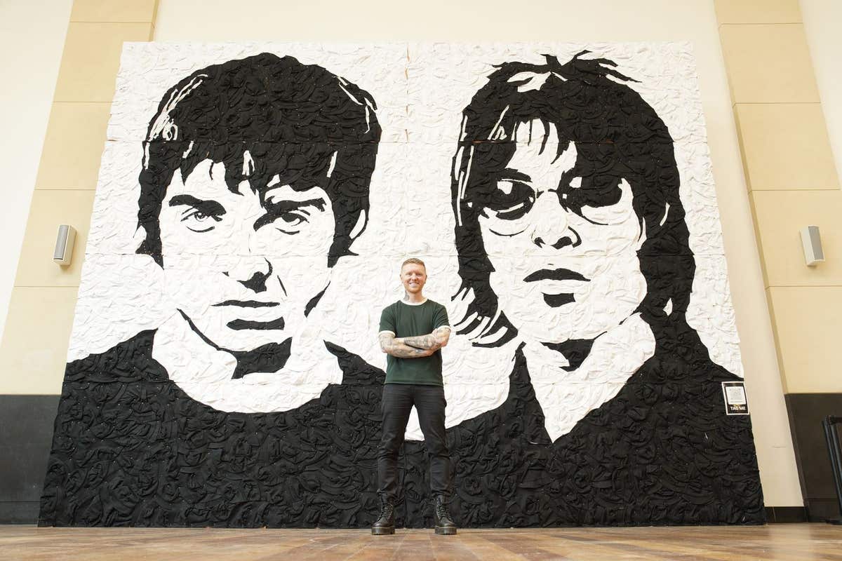 EDITORIAL USE ONLY Artist Nathan Wyburn with his artwork ‘The Wonder Wall’, a monochrome portrait of Oasis bandmates Noel and