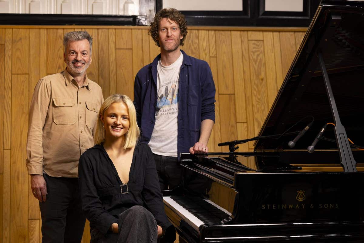 EDITORIAL USE ONLY Mel Raeburn with producers Tim Bran (L) and Ben Burrows (R) during the recording of her version of ???Sonn