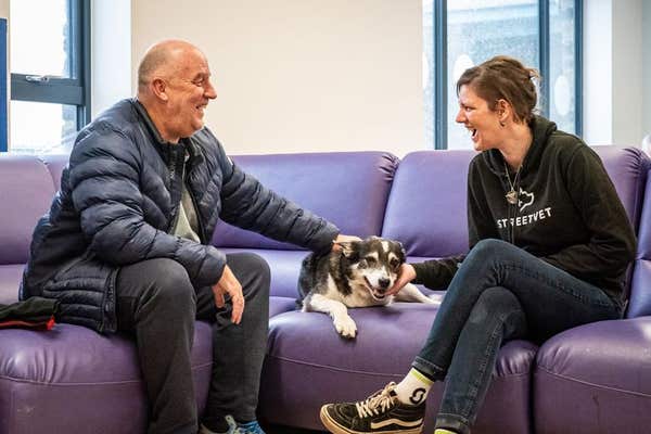 EDITORIAL USE ONLY Andy and Jess chat with StreetVet support volunteer, Karis Matik, as they attend a collaborative event hos