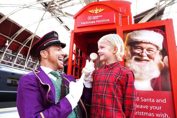 EDITORIAL USE ONLY Joe Swash dresses as a bellboy and surprises Jimmy-Judson Simmons, aged 8, at Paddington Station as part o
