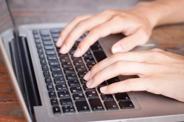 H400J6 Person typing on a computer keyboard