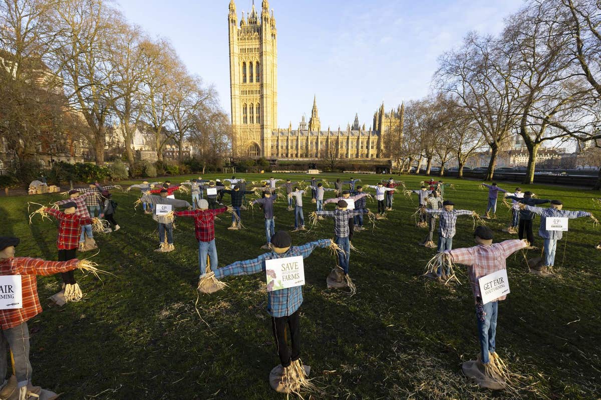 EDITORIAL USE ONLY A view of 49 scarecrows outside the Houses of Parliament in London, as part of Riverford’s ‘Get Fair About