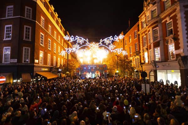 EDITORIAL USE ONLY Members of the public watch the Merry Marylebone Christmas lights switch-on in Marylebone Village in Londo