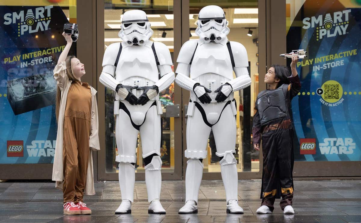 EDITORIAL USE ONLY (left to right) Honor, aged 11 and Noah aged 10, each dressed as a Star Wars character, test the Lego grou