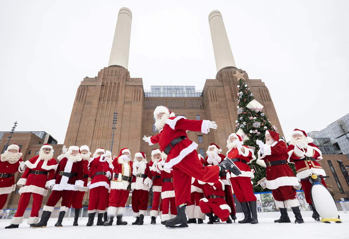 EDITORIAL USE ONLY Father Christmas performers at Ministry of Fun’s annual Santa School ice skate at London’s only riverside