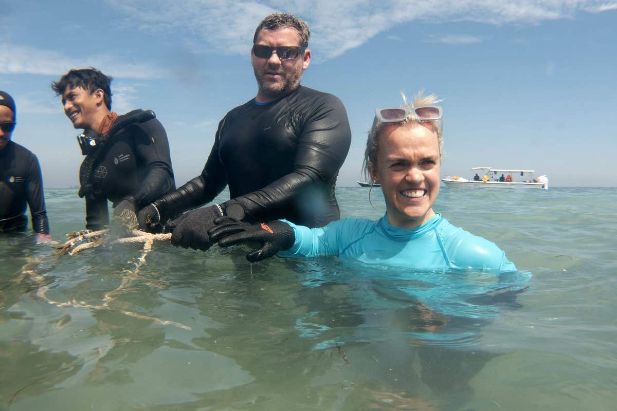 EDITORIAL USE ONLY Paralympian swimmer Ellie Simmonds joins Professor David Smith, Chief Marine Scientist Mars (centre), on a