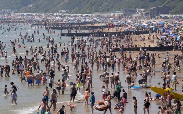 People enjoy the hot weather on Bournemouth beach in Dorset. Monday is set to be the hottest bank Holiday on record, reaching