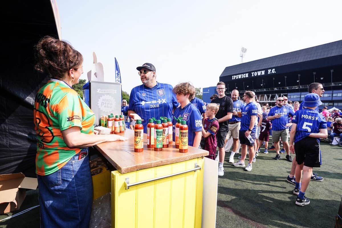 EDITORIAL USE ONLY Fans tuck into ‘Handy Tingly Pies’, a new collaboration between Ed Sheeran’s hot sauce brand, Tingly Ted’s