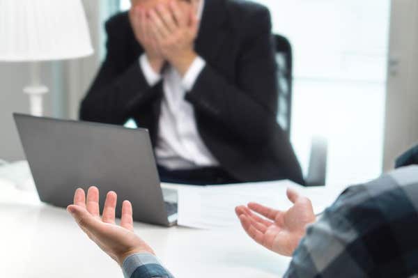 M4AJ78 Failed job interview or business people having fight in office. Businessman covering and holding face with hands in me