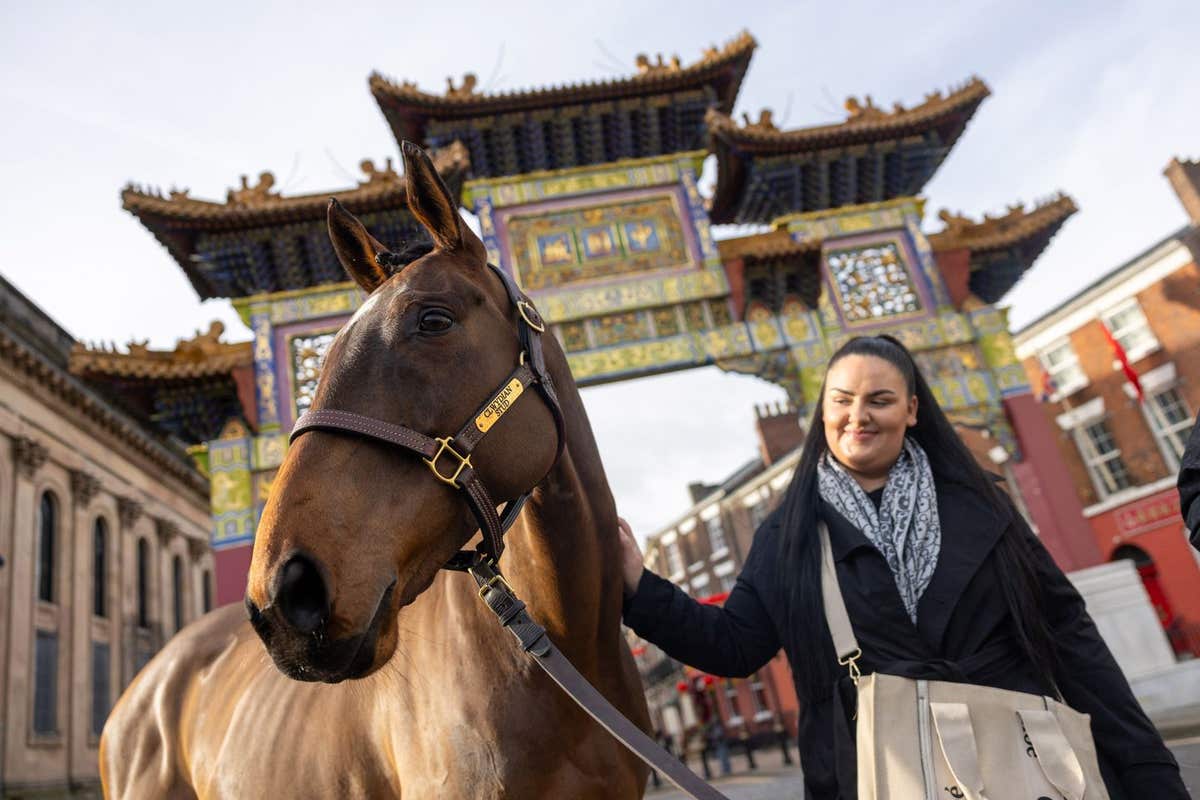 EDITORIAL USE ONLY Chloe Cowley meets racehorse Kemboy as they visit Liverpool’s Chinatown with Great British Racing to celeb