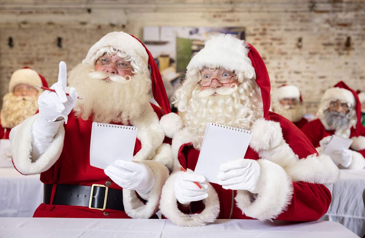 EDITORIAL USE ONLY Men dressed as Father Christmas performers take part in Ministry of Fun’s annual Santa School training, at
