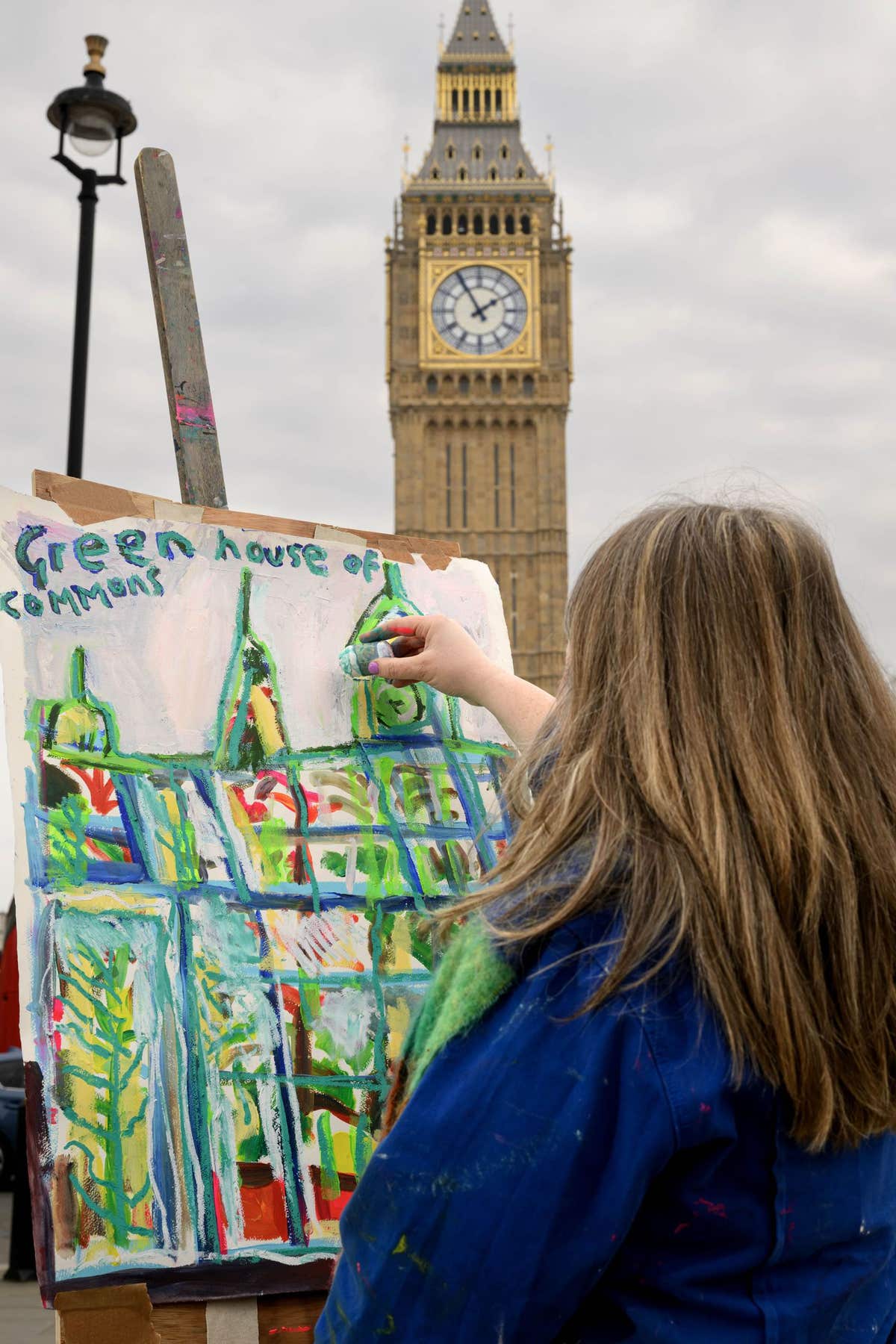 EDITORIAL USE ONLY Artist Emily Powell paints outdoors in front of the Winston Churchill sculpture in Parliament Square, prev