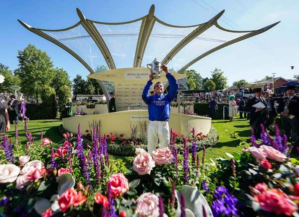 William Buick celebrates with the trophy after winning the St James’s Palace Stakes on Coroebus during day one of Royal Ascot