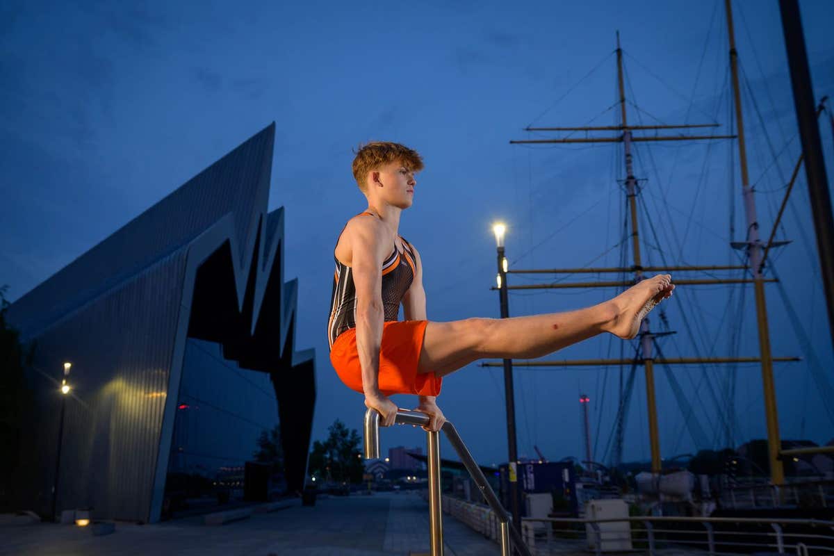 EDITORIAL USE ONLY Scottish Gymnast Aaron Convery performs at Riverside Museum in Glasgow at sunset as part of an EDF campaig