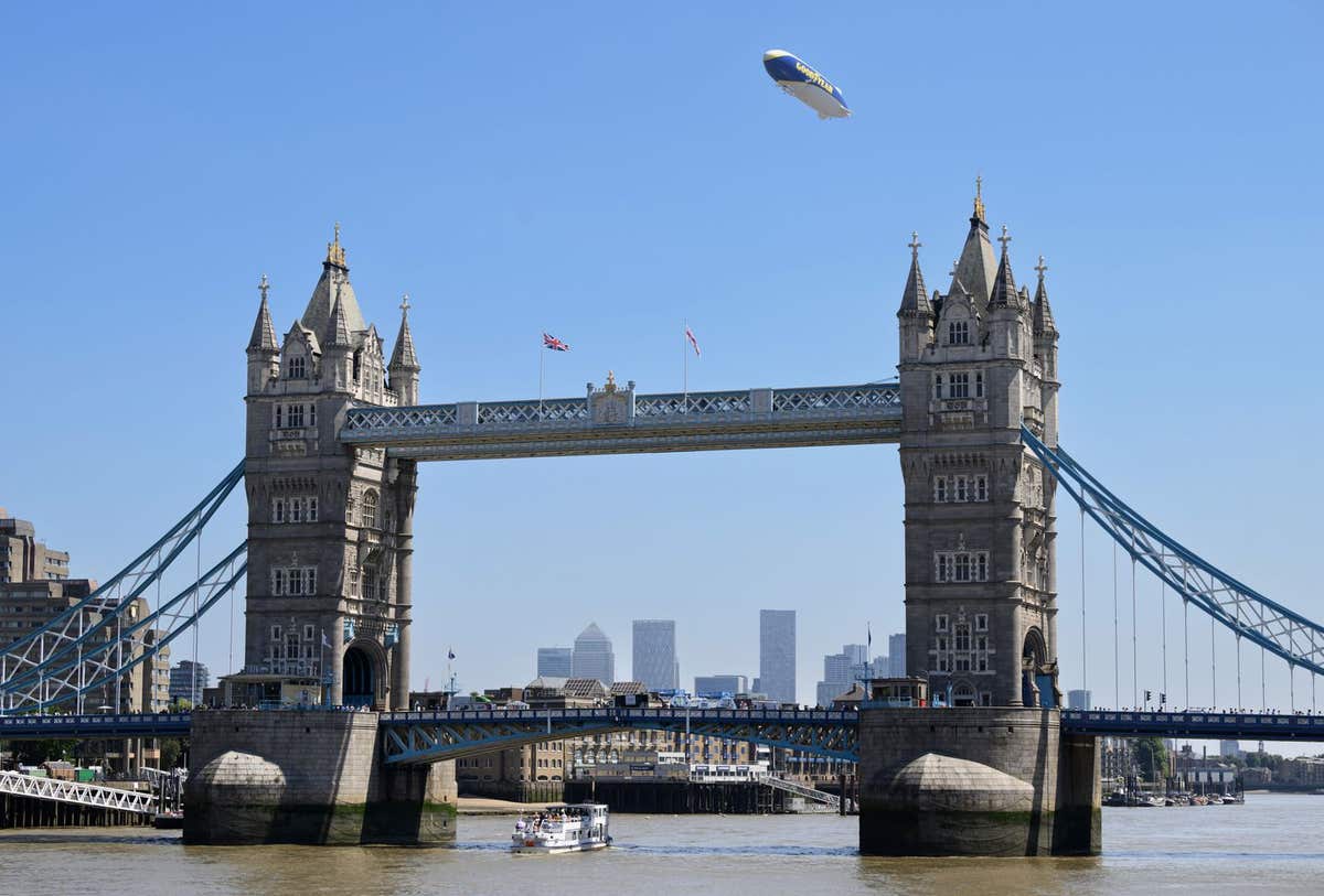 EDITORIAL USE ONLY General view of the Goodyear Blimp flying over Tower Bridge in London during its UK tour in its 101st year