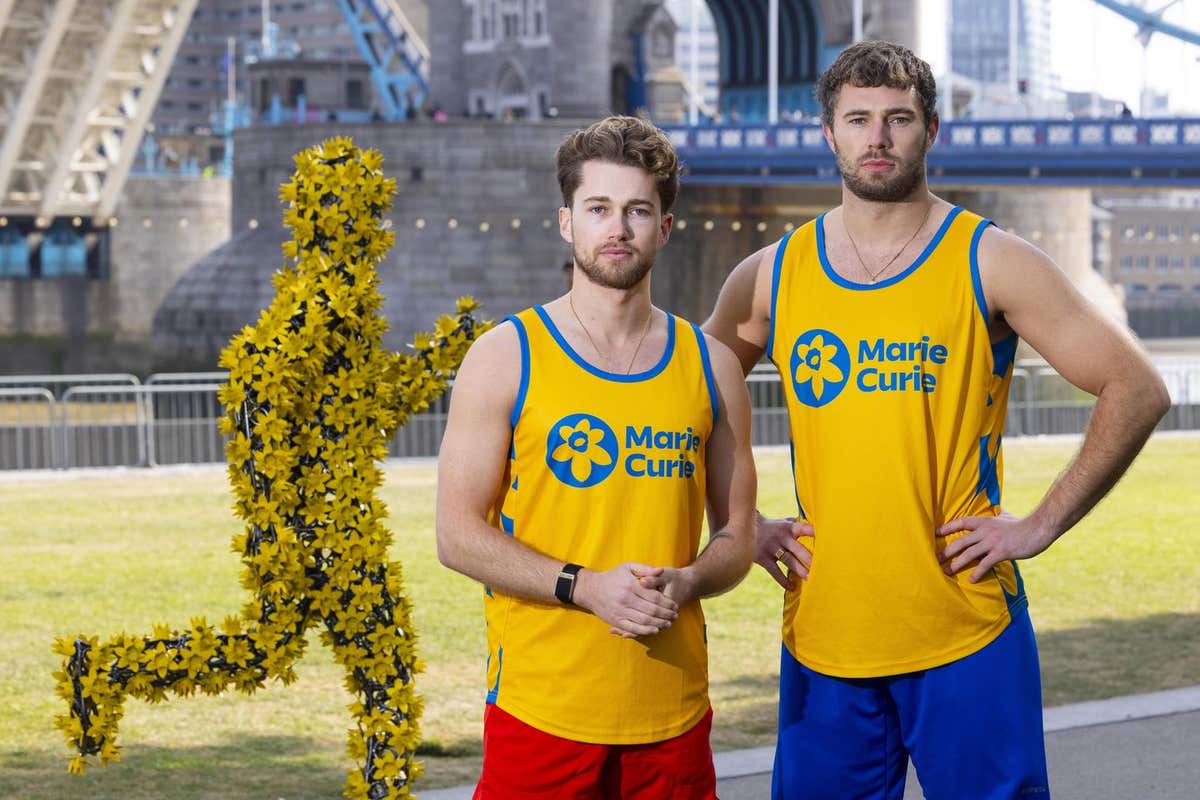 EDITORIAL USE ONLY AJ & Curtis Pritchard unveil The Daffodil Runner, commissioned by Marie Curie, the 2026 TCS London Maratho