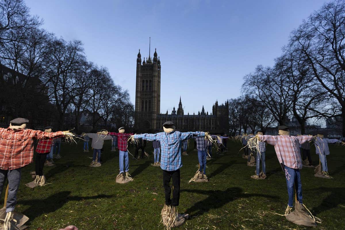 EDITORIAL USE ONLY A view of 49 scarecrows outside the Houses of Parliament in London, as part of Riverford’s ‘Get Fair About