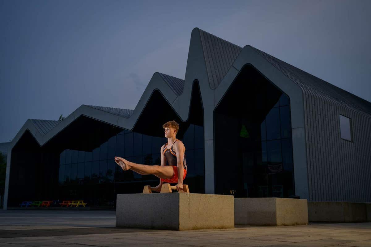 EDITORIAL USE ONLY Scottish Gymnast Aaron Convery performs at Riverside Museum in Glasgow at sunset as part of an EDF campaig