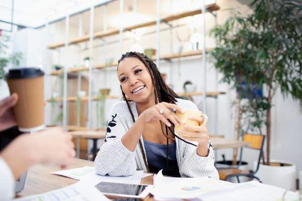 2A85ANK Businesswoman drinking coffee in meeting