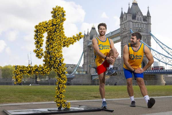EDITORIAL USE ONLY AJ & Curtis Pritchard unveil The Daffodil Runner, commissioned by Marie Curie, the 2026 TCS London Maratho