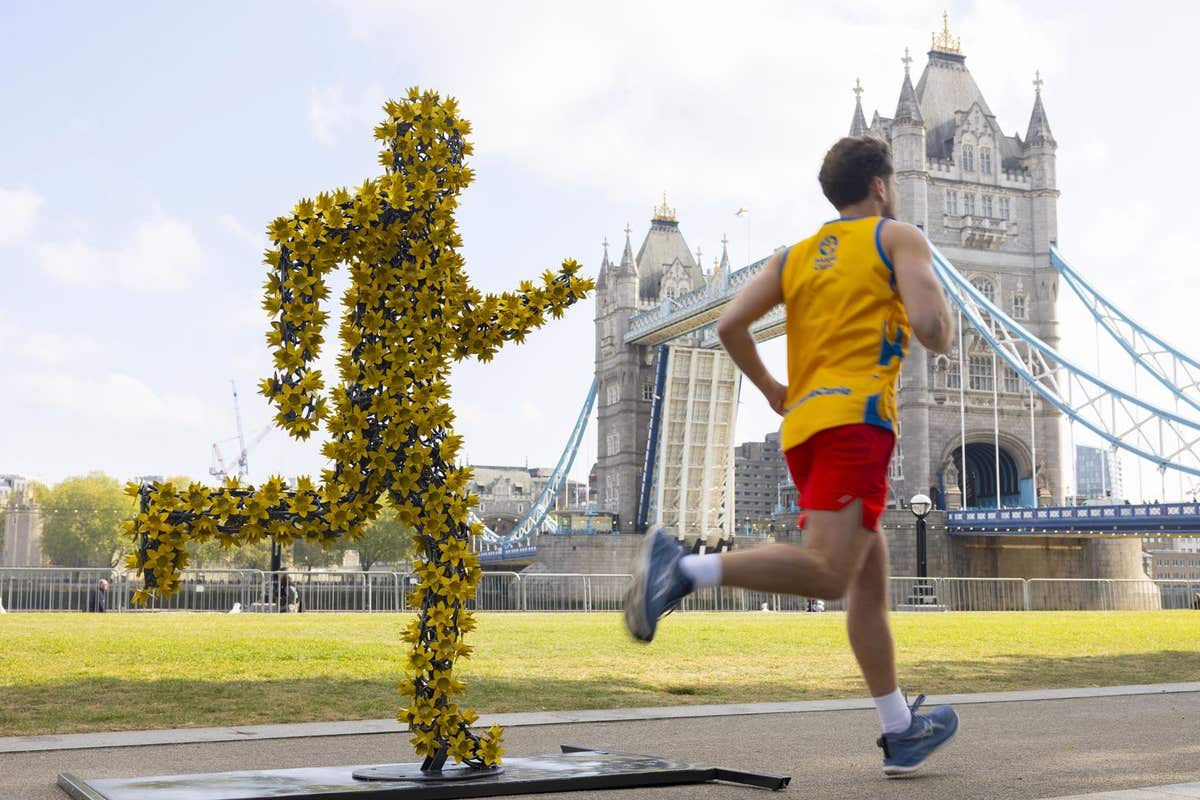 EDITORIAL USE ONLY AJ & Curtis Pritchard unveil The Daffodil Runner, commissioned by Marie Curie, the 2026 TCS London Maratho