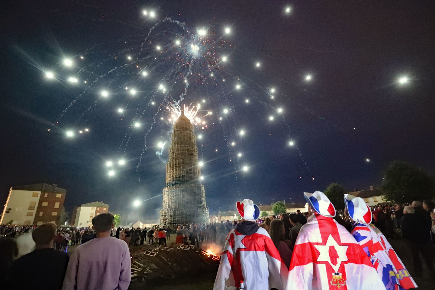 Crowds watch a fireworks display before the huge bonfire in the loyalist Corcrain area of Portadown, Co Armagh, is lit on the "Eleventh night" to usher in the Twelfth commemorations. 