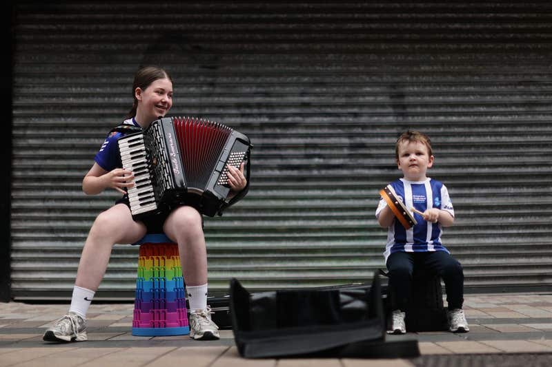  Lilly Rose Grant, 13, playing the accordion with her brother Pauric Grant, four, on Fountain Street at Fleadh Cheoil na h�ireann 2026, which has officially opened in Belfast kicking off a week of song, dance and culture as part of the world's largest celebration of traditional Irish music.