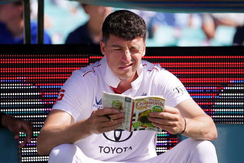 England's Matthew Fisher reads a crossword book on day two of the fifth NRMA Insurance Ashes Series 2025 test at the Sydney Cricket Ground, Australia. Picture date: Monday January 5, 2026.