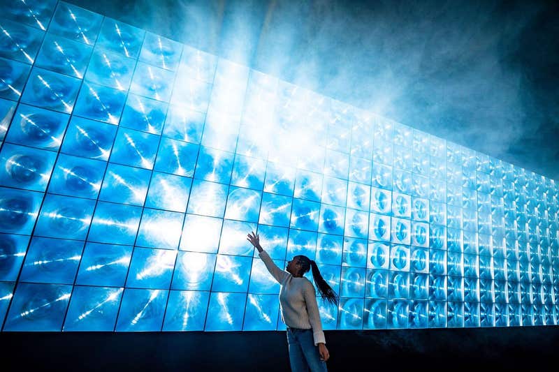 Law student at Plymouth University, Elysha Joseph, touches light panels as she walks through an art installation called Sola by the art collective Squidsoup, at Illuminate, the annual light art event at Royal William Yard in Plymouth, where the event is returning to showcase immersive digital installations. Picture date: Monday November 15, 2021.